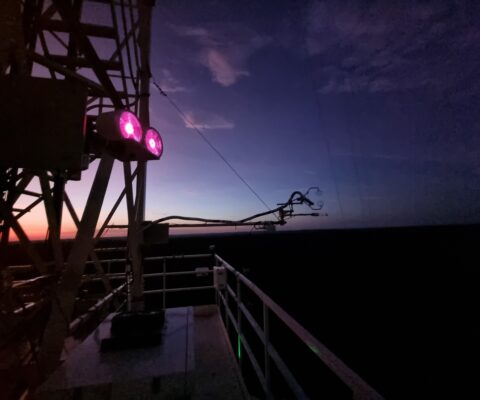 Another is installed on the tall tower, glowing in the dark. © CloudRoots Team